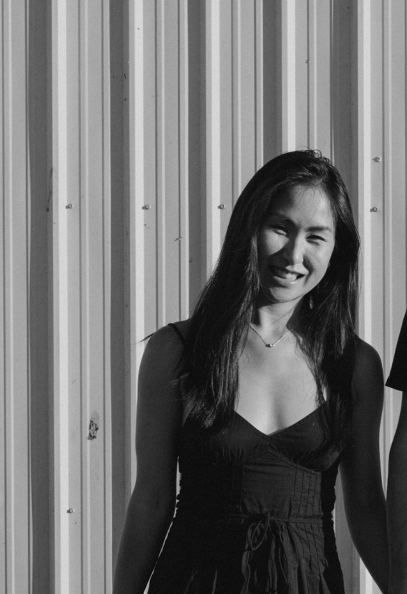 Samantha Co laughing in front of a corrugated metal wall